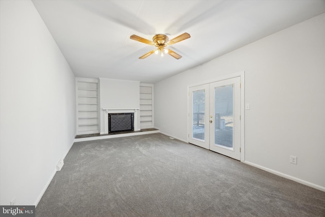 unfurnished living room with french doors, carpet flooring, ceiling fan, and built in shelves