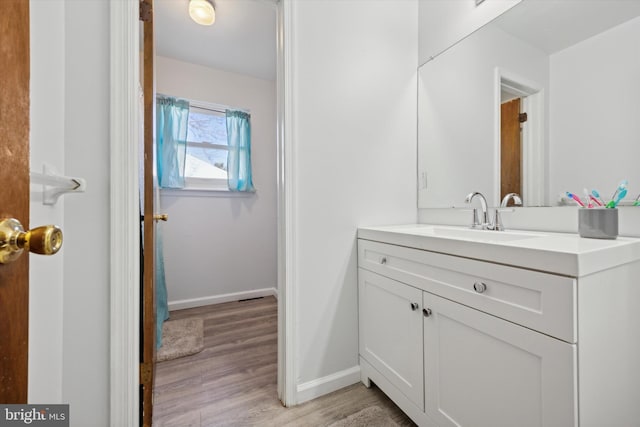 bathroom with vanity and hardwood / wood-style flooring