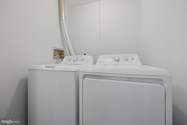 clothes washing area with separate washer and dryer