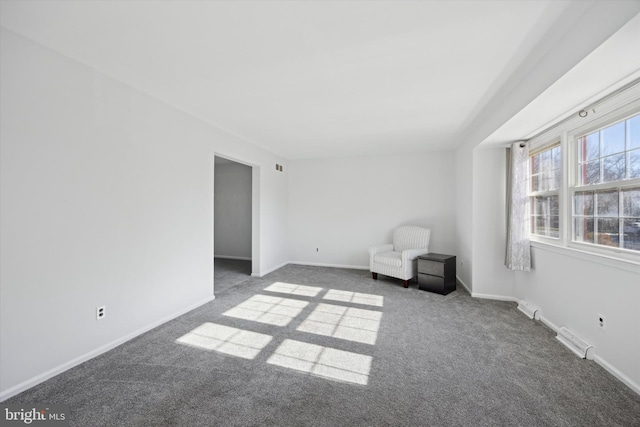 unfurnished room with dark carpet