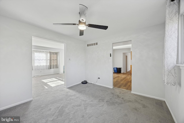 spare room featuring carpet flooring and ceiling fan