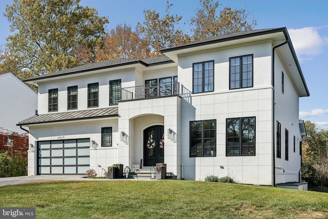 view of front of home with a balcony, a front lawn, and a garage