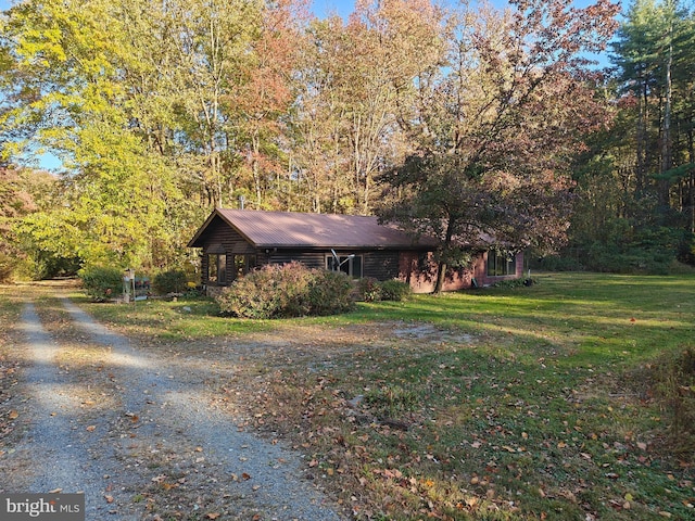 view of home's exterior with a yard