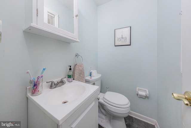 bathroom featuring toilet and vanity