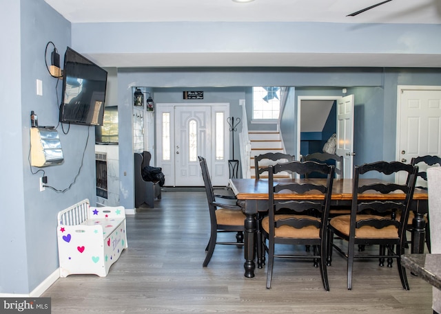 dining room featuring stairway, wood finished floors, and baseboards