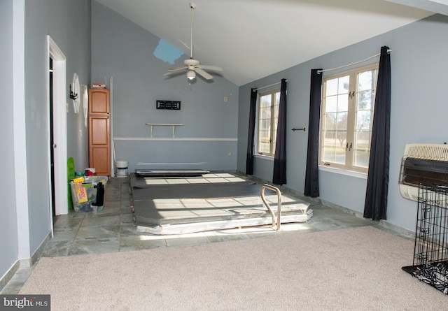 living area featuring high vaulted ceiling, light colored carpet, a ceiling fan, baseboards, and heating unit