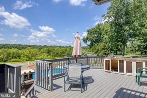 wooden deck with a fenced in pool