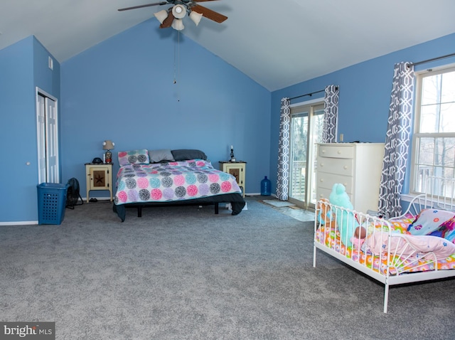 carpeted bedroom with vaulted ceiling, a closet, a ceiling fan, and baseboards