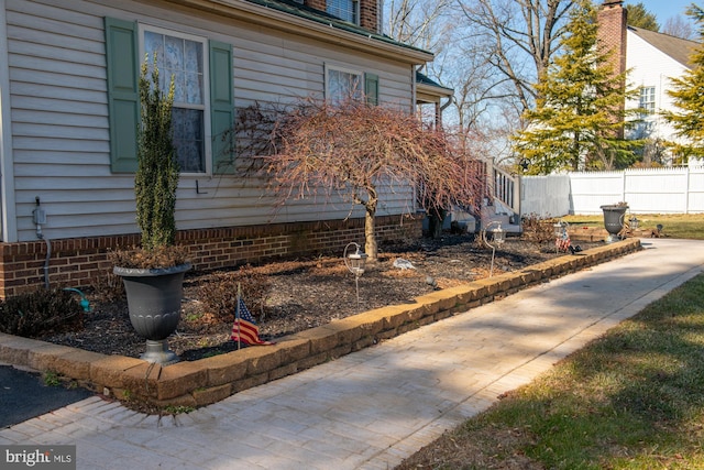 view of home's exterior with fence