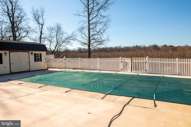 view of swimming pool featuring a fenced in pool, fence, and a patio