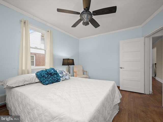 bedroom with ceiling fan, crown molding, and dark wood-type flooring