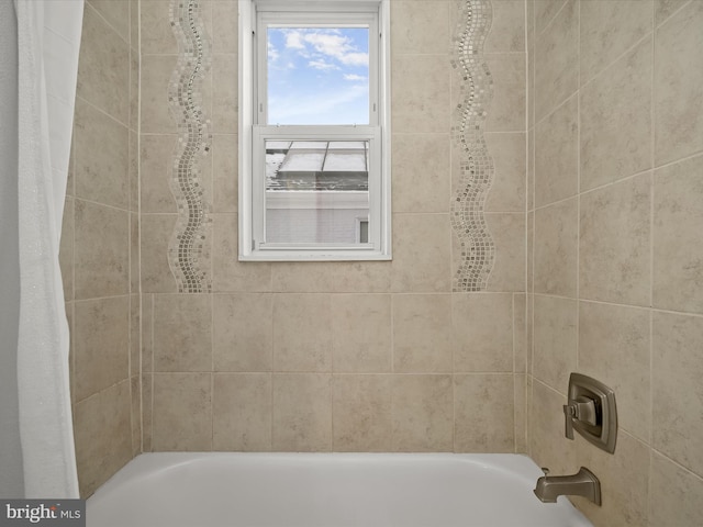 bathroom featuring shower / tub combo with curtain