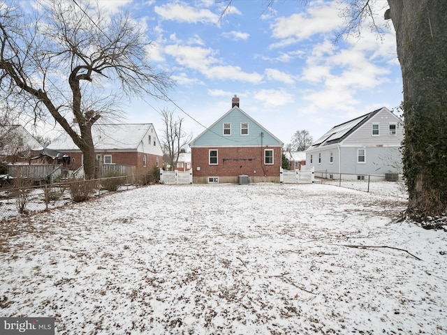 snow covered property featuring central AC