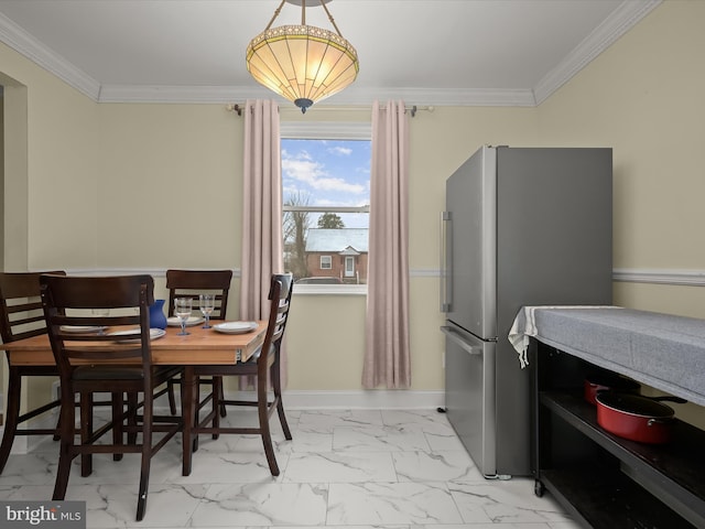 dining space featuring crown molding