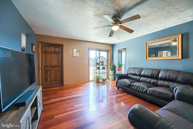 living room with dark hardwood / wood-style floors and ceiling fan