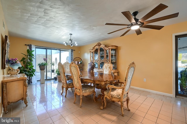 tiled dining room with ceiling fan with notable chandelier