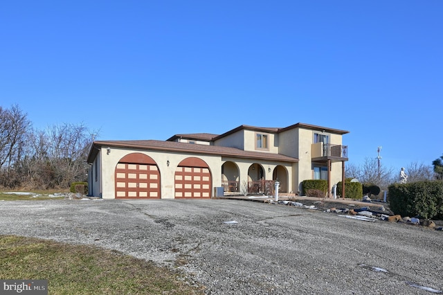 view of front of home with a balcony and a garage