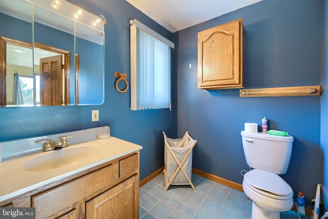 bathroom featuring vanity, toilet, and tile patterned flooring