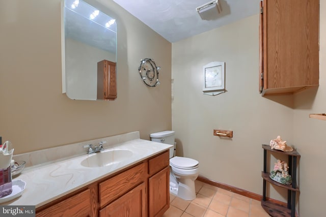 bathroom featuring tile patterned flooring, vanity, and toilet