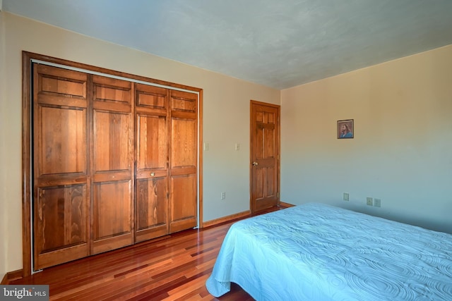 bedroom featuring hardwood / wood-style floors and a closet