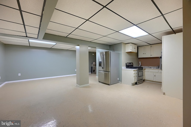 basement featuring a drop ceiling and stainless steel fridge with ice dispenser