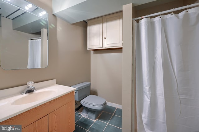 bathroom featuring vanity, tile patterned floors, and toilet