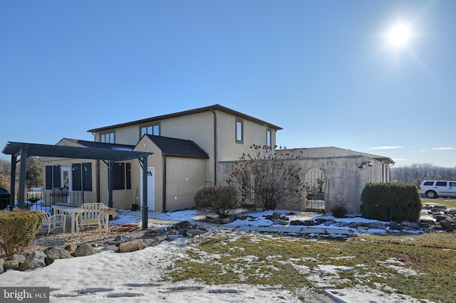 view of snow covered rear of property