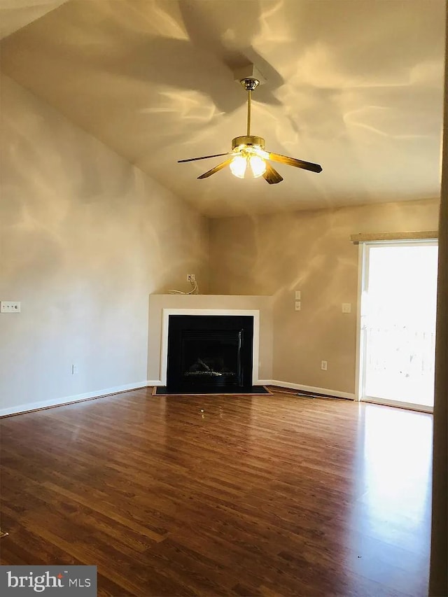 unfurnished living room with ceiling fan and dark hardwood / wood-style flooring