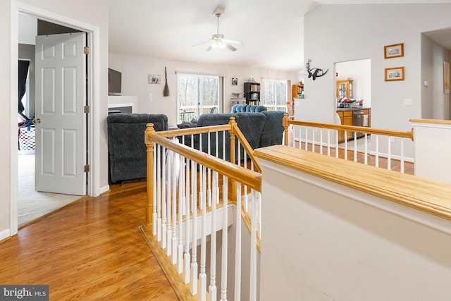 corridor featuring hardwood / wood-style flooring and lofted ceiling