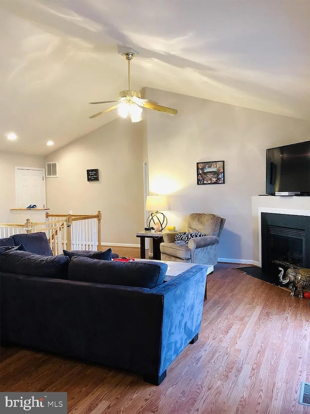 living room featuring lofted ceiling, hardwood / wood-style floors, and ceiling fan