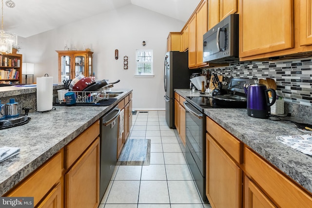 kitchen featuring light tile patterned flooring, decorative light fixtures, vaulted ceiling, stainless steel appliances, and backsplash