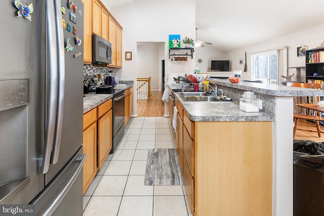 kitchen featuring range with electric stovetop, vaulted ceiling, light tile patterned flooring, an island with sink, and stainless steel refrigerator with ice dispenser