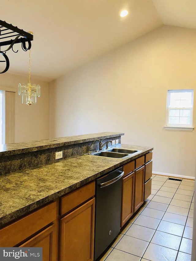 kitchen with pendant lighting, sink, light tile patterned floors, lofted ceiling, and dishwasher