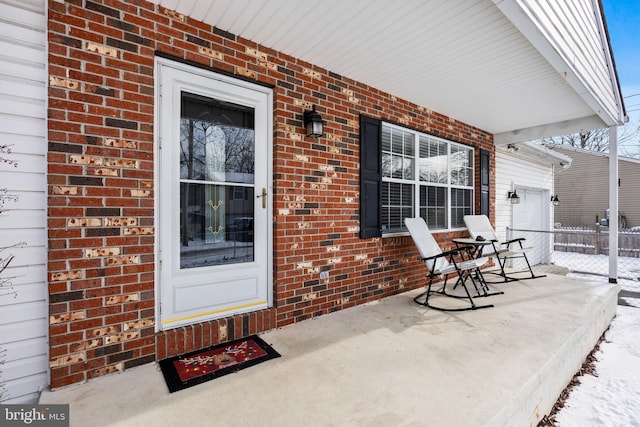 view of patio with covered porch and a garage