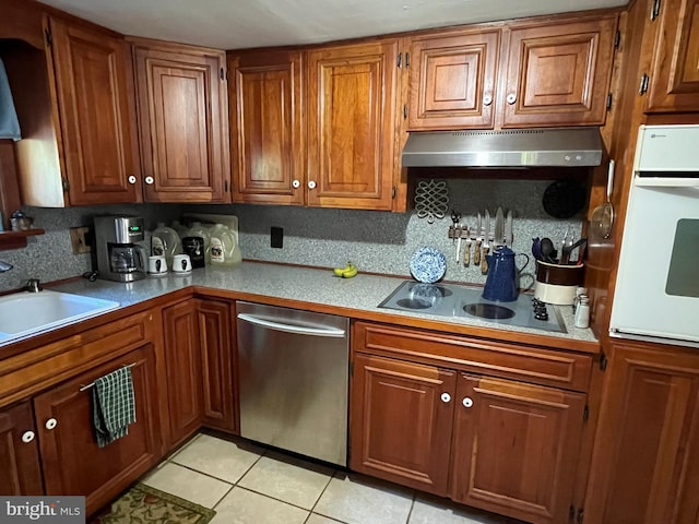 kitchen with stovetop, light tile patterned floors, sink, oven, and stainless steel dishwasher