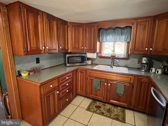 kitchen featuring sink, light tile patterned floors, and appliances with stainless steel finishes