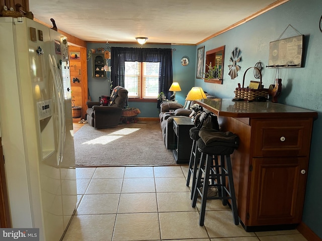 carpeted living room featuring bar and crown molding