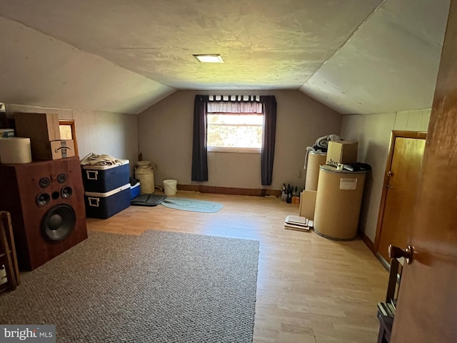 bonus room with vaulted ceiling and light hardwood / wood-style floors