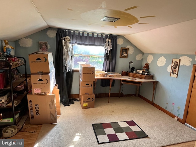 interior space with vaulted ceiling and light carpet