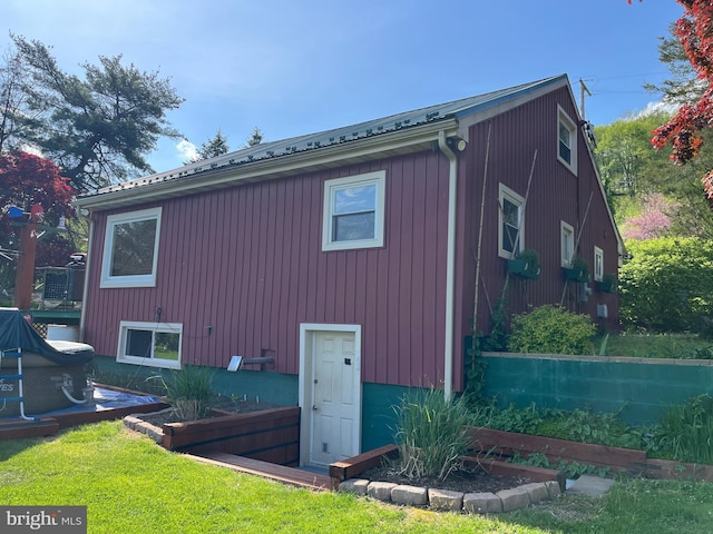 view of property exterior with a lawn