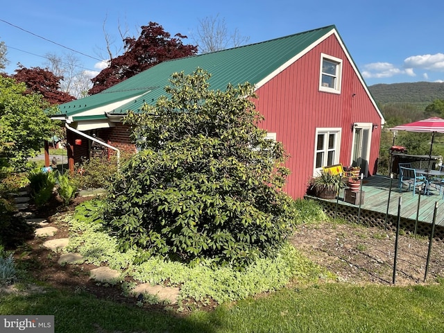 view of side of property with a deck