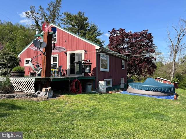 back of house featuring a lawn and a covered pool