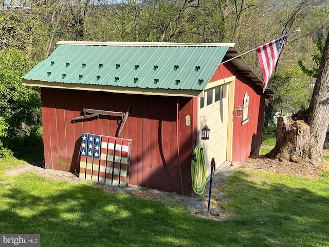 view of outbuilding with a yard