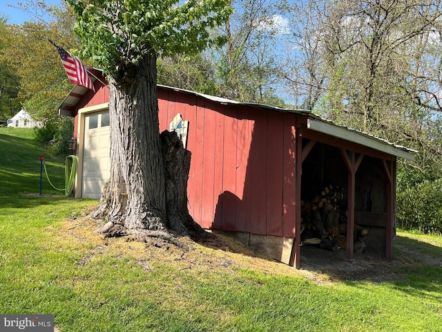 view of outdoor structure featuring a lawn