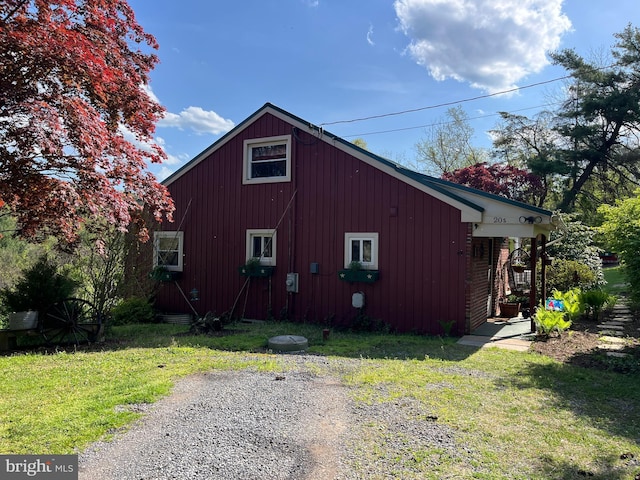 view of property exterior with a yard