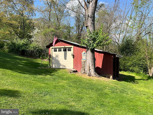 view of outbuilding featuring a lawn and a garage