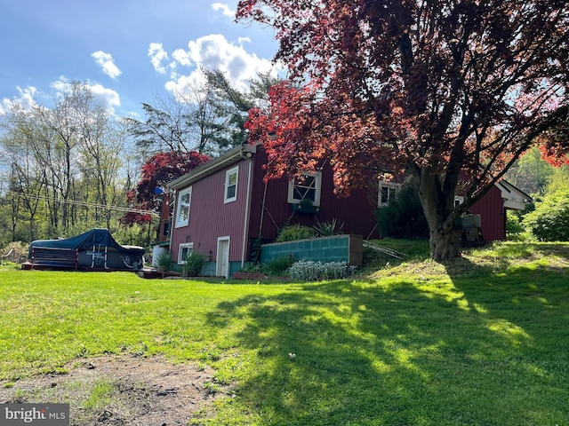 view of property exterior featuring a yard