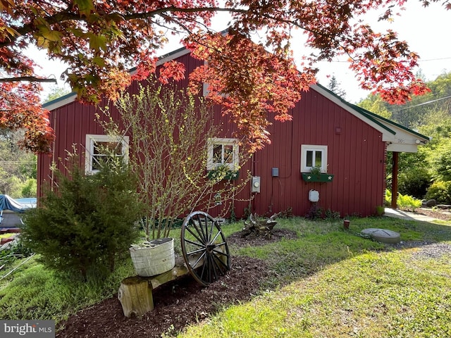 view of side of property with a lawn