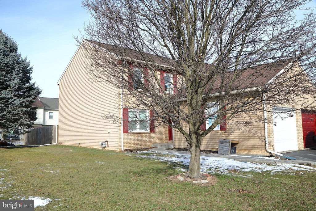 view of home's exterior featuring a yard and a garage