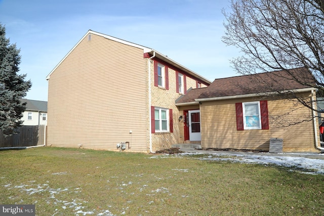 rear view of house with a yard